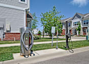 Thumbnail 33 of 43 - a gas pump on the side of a street in front of houses