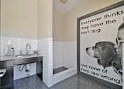 Thumbnail 28 of 43 - a dog in a bathroom with a sign that says everyone thinks they have the best