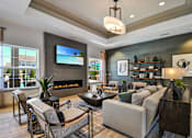 Thumbnail 20 of 43 - a living room with couches and chairs and a fireplace