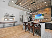 Thumbnail 21 of 43 - a kitchen with a bar and a table with chairs