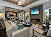 Thumbnail 19 of 43 - a living room with a couch and a fireplace