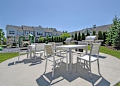 Thumbnail 30 of 43 - an outdoor patio with tables and chairs and a playground