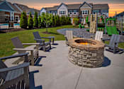 Thumbnail 31 of 43 - an outdoor patio with a fire pit and benches