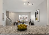Thumbnail 4 of 47 - A living room with a marble table and a bowl of lemons on it.