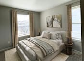Thumbnail 47 of 47 - A bedroom with a large bed and a window with curtains.