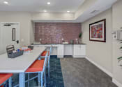 Thumbnail 28 of 41 - a dining room with a long table and chairs and a brick wall