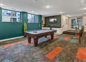 Thumbnail 24 of 41 - a game room with a pool table and a tv
