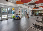 Thumbnail 20 of 41 - the preserve at cardinal woods fitness room with exercise equipment and windows