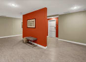 Thumbnail 38 of 41 - an empty room with an orange wall and a chair