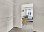 Thumbnail 11 of 41 - a bedroom with a closet and two hanging racks on the wall