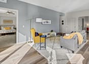 Thumbnail 5 of 41 - a living room with a gray couch and yellow chairs