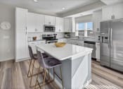 Thumbnail 1 of 41 - a white kitchen with stainless steel appliances and a white counter top