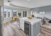 Thumbnail 3 of 41 - a kitchen with a large island and a living room with a table and chairs