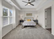 Thumbnail 7 of 41 - a bedroom with a bed and a ceiling fan