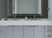 Thumbnail 29 of 43 - a bathroom with a sink and a mirror