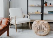 Thumbnail 19 of 43 - a living room with a book shelf and a chair