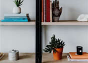 Thumbnail 23 of 43 - a bookshelf with books and plants on it