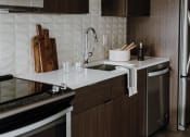 Thumbnail 5 of 43 - a kitchen with a stove a sink and a microwave