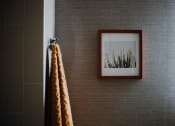 Thumbnail 31 of 43 - a picture hanging on a wall next to a towel