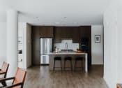 Thumbnail 7 of 43 - a kitchen with a center island and a stove top oven