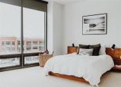 Thumbnail 24 of 43 - a bedroom with a large bed next to a window