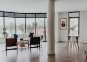 Thumbnail 16 of 43 - a living room and dining room with large windows