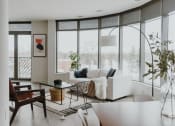 Thumbnail 14 of 43 - a living room with large windows and a white couch