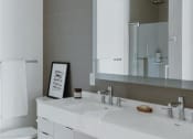 Thumbnail 34 of 43 - a bathroom with a white toilet and a large mirror