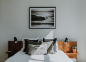 Thumbnail 25 of 43 - a bedroom with a large painting above the bed