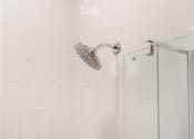 Thumbnail 32 of 43 - a white bathroom with a shower and a small shelf
