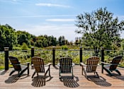 Thumbnail 33 of 42 - A set of six chairs are arranged on a wooden deck.