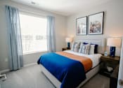 Thumbnail 11 of 43 - A bedroom with a large bed and two lamps.