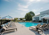 Thumbnail 36 of 43 - A pool with sun loungers and umbrellas.