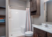 Thumbnail 2 of 17 - A bathroom with a toilet, sink, and shower.