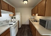 Thumbnail 26 of 29 - A kitchen with white appliances and wooden cabinets.