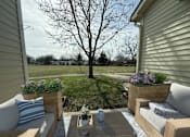 Thumbnail 29 of 29 - A backyard with a table, chairs, and a tree.