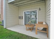 Thumbnail 18 of 35 - a small porch with a table and a chair on it