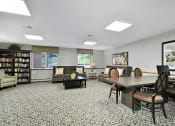 Thumbnail 23 of 35 - the preserve at cardinal woods resident lounge and library with tables and chairs