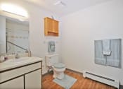 Thumbnail 17 of 35 - a bathroom with a toilet and a sink and a mirror