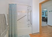 Thumbnail 16 of 35 - a bathroom with a shower and a towel rack in it