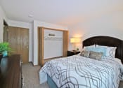 Thumbnail 15 of 35 - a bedroom with a large bed and a closet
