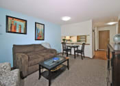 Thumbnail 10 of 35 - a living room and dining room with a couch and a table
