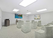 Thumbnail 20 of 35 - a meeting room with chairs and a table and a projector