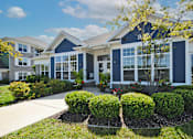 Thumbnail 21 of 21 - a blue clubhouse with a sidewalk in front of it