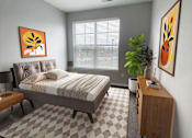 Thumbnail 6 of 21 - A bedroom with a bed, nightstand, and a plant.