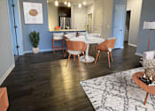 Thumbnail 4 of 21 - A dining room with a table set for four.