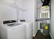 Thumbnail 9 of 21 - a laundry room with a washer and dryer and a water heater