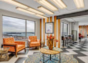 Thumbnail 32 of 41 - A living room with a view of the ocean through the windows.