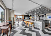 Thumbnail 26 of 41 - A modern kitchen with a bar area and a view of the city.