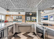 Thumbnail 25 of 41 - A modern kitchen with a checkered floor and stainless steel appliances.